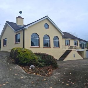 Traditional exterior house painted yellow with red trims after refurbishment