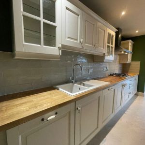 Kitchen cabinets after removed laminate with new worktop and white sink