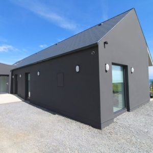A coastal house in West Cork featuring a bold black exterior paint finish.