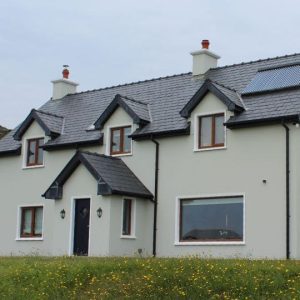 Exterior house painted grey after refurbishment.