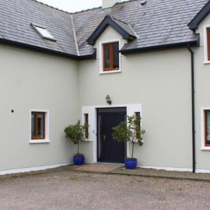 Exterior House entrance area grey with black door.