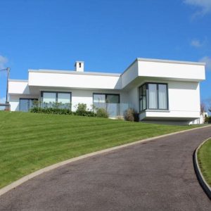 Exterior luxury bungalow painted white with black windows