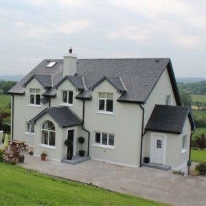 Exterior painted green with white trims and black door after refurbishment