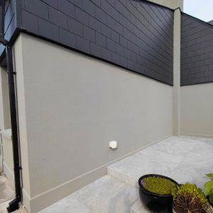 Exterior side wall grey and black cladding.