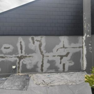 Exterior wall crack repair in progress.