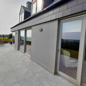 Exterior bungalow walls grey with large glass doors