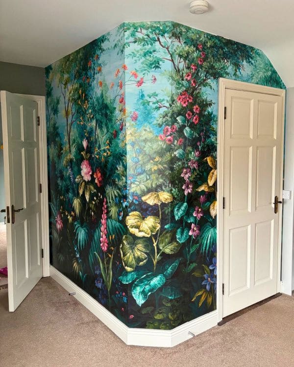 Wallpaper mural with colourful large flowers and plants in a tropical environment.